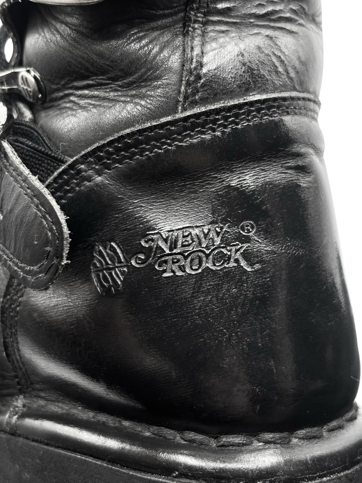 Black boot ankle panel with embossed New Rock logo