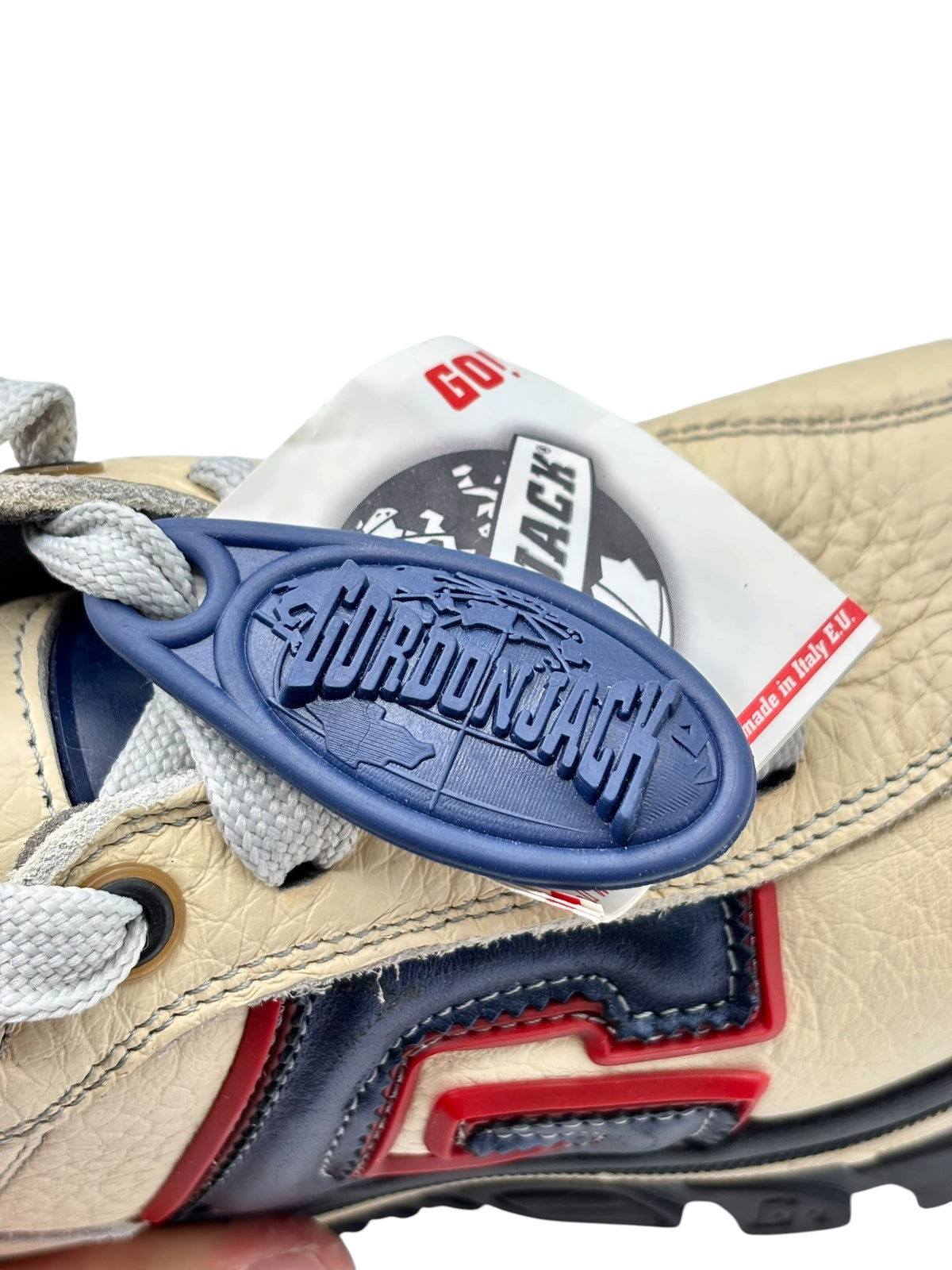 Blue GORDONJACK logo patch on beige sneaker tongue label area