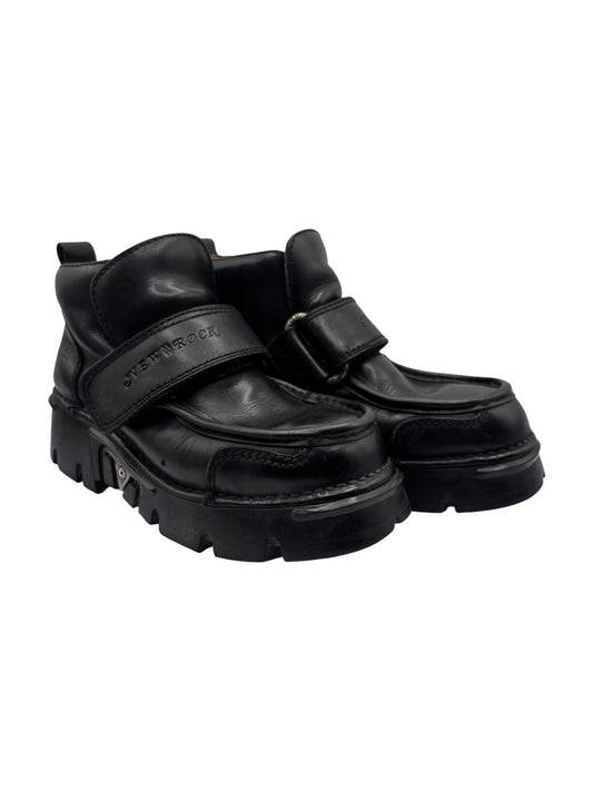 Black leather platform boots with dual Velcro straps, chunky lug sole