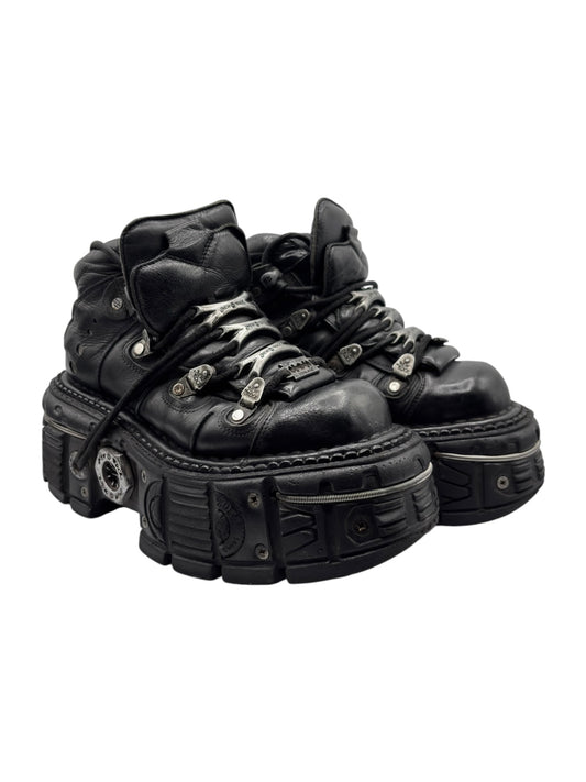 Black platform lace-up boots with chunky stacked sole and metal studs/buckles