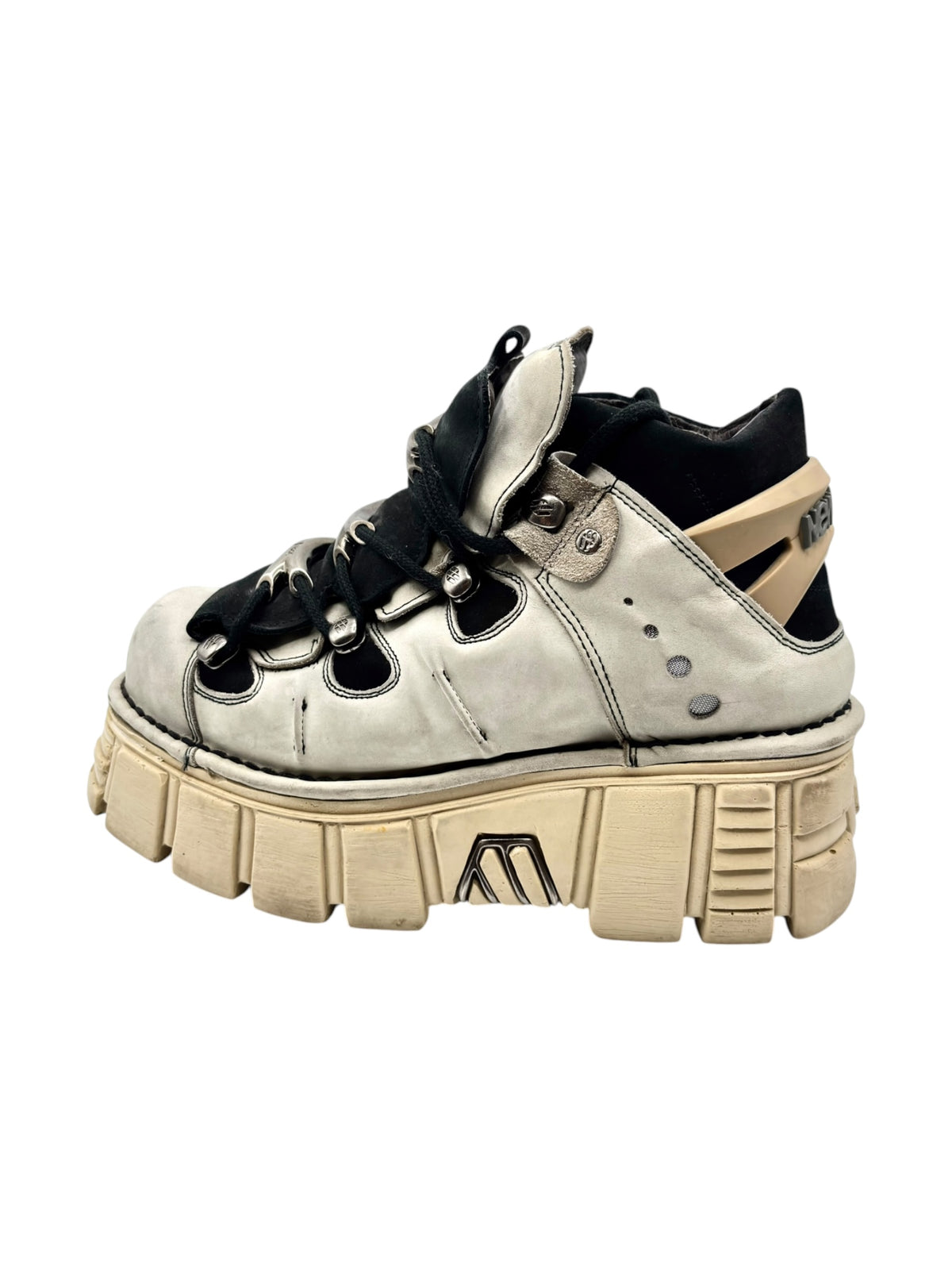 Beige and black platform lace-up boot with thick tan lug sole and metal eyelets