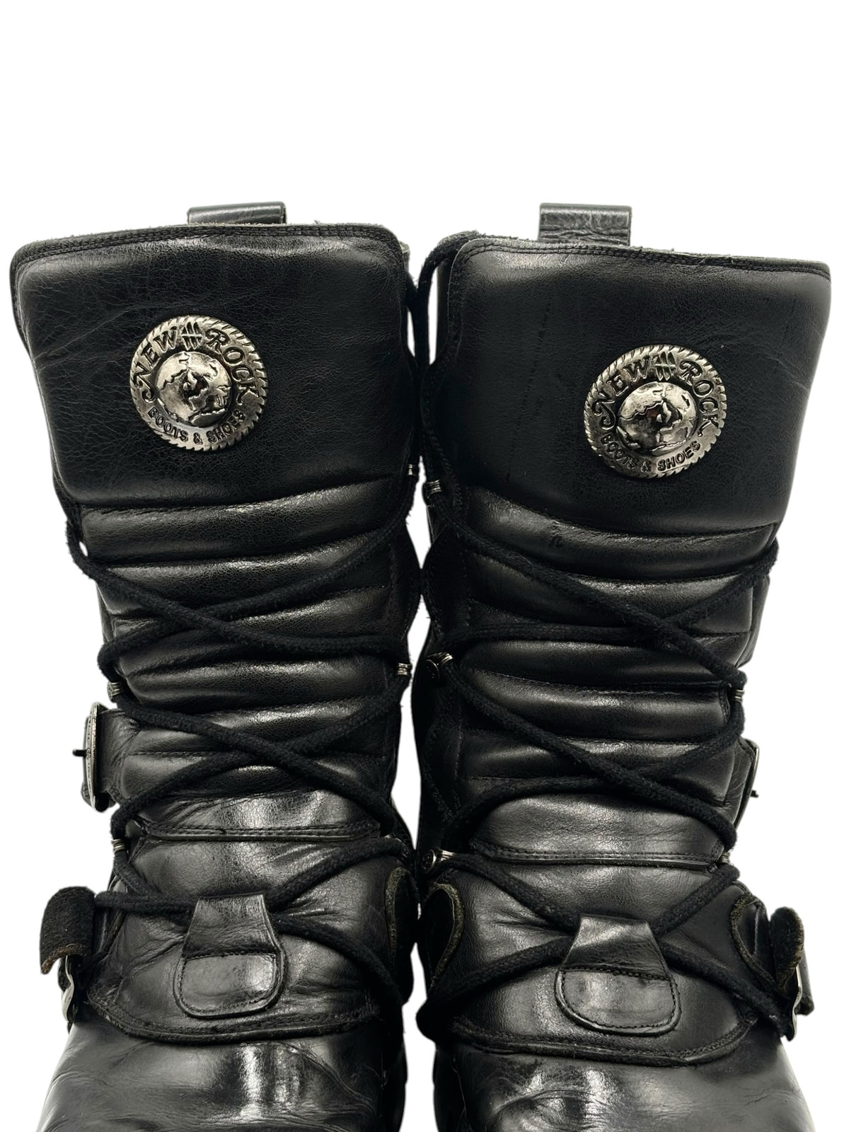 Black mid-calf reactor boots with lace-up panels and round logo discs on outer sides