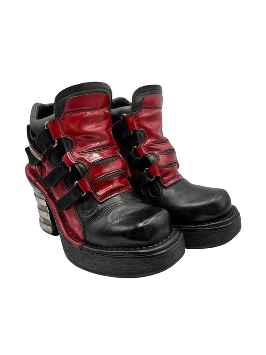 Black and red leather high-top platform ankle boots with buckled straps and chunky heel