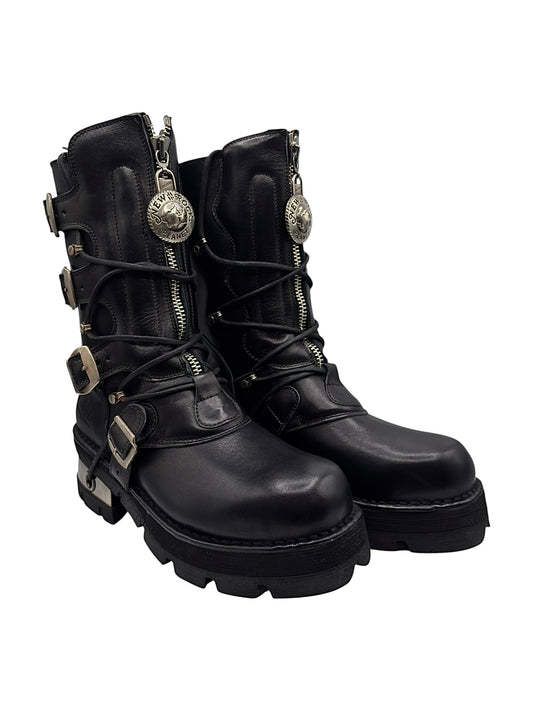 Black leather mid-calf boots with side zippers, buckle straps, and chunky tread sole