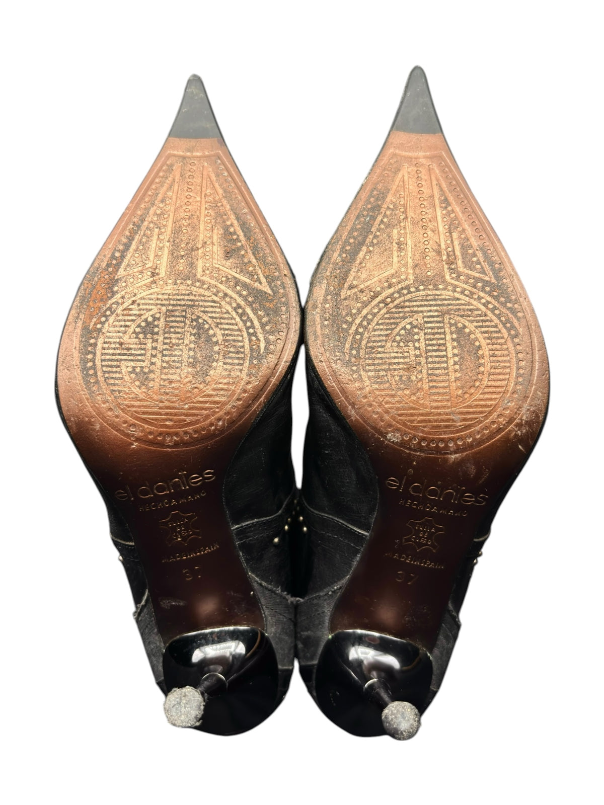 Pair of knee-high boots with pointed toes, tan embossed panels, black shaft tops