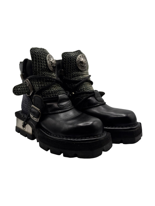 Black platform boots with chunky sole, buckle straps, and textured studded ankle panels