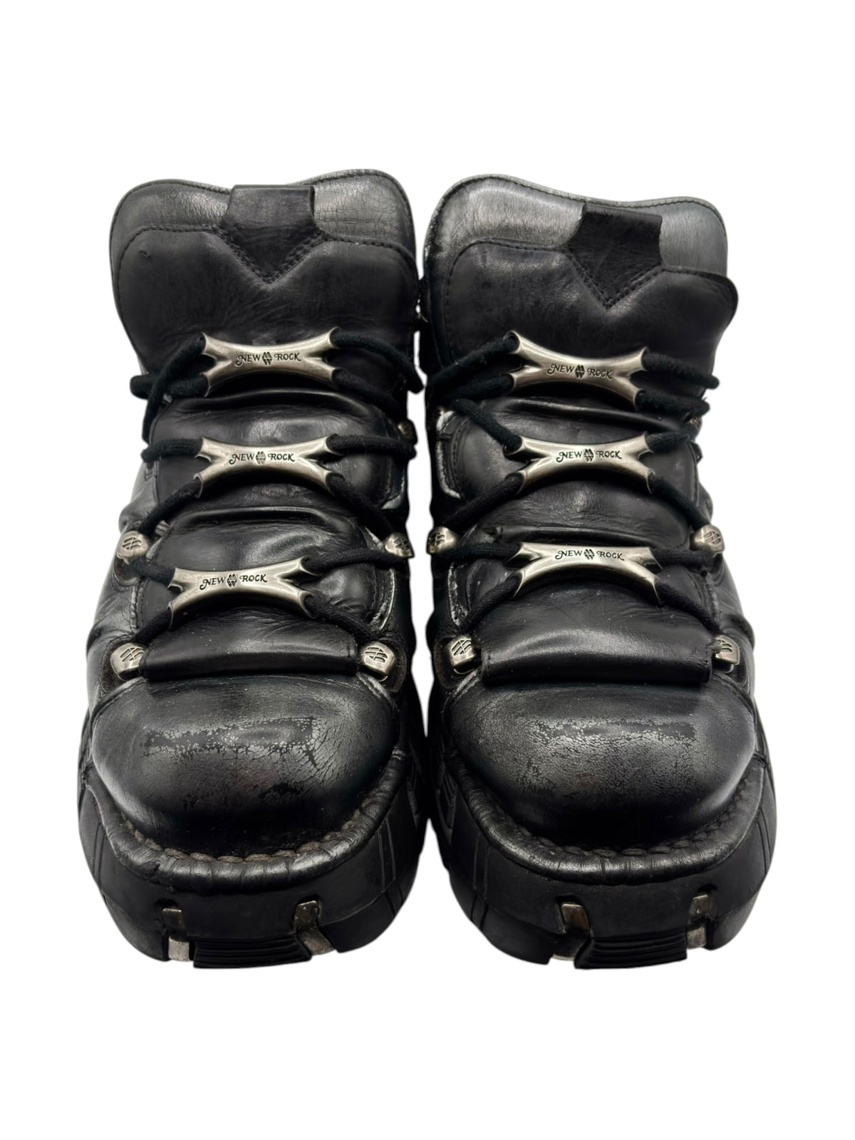 Back view of black lace-up platform boots with layered straps and chunky heel tread
