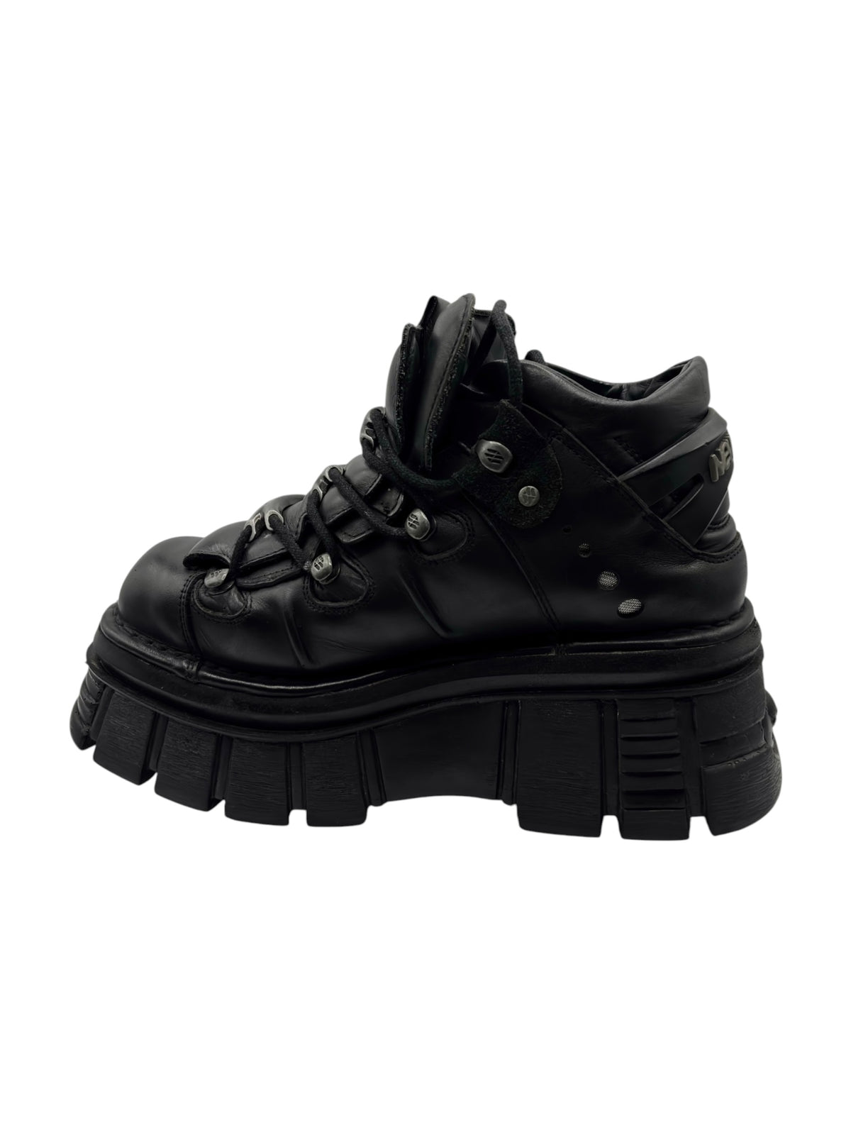 Black lace-up platform boots, side view showing thick treaded sole and hardware eyelets