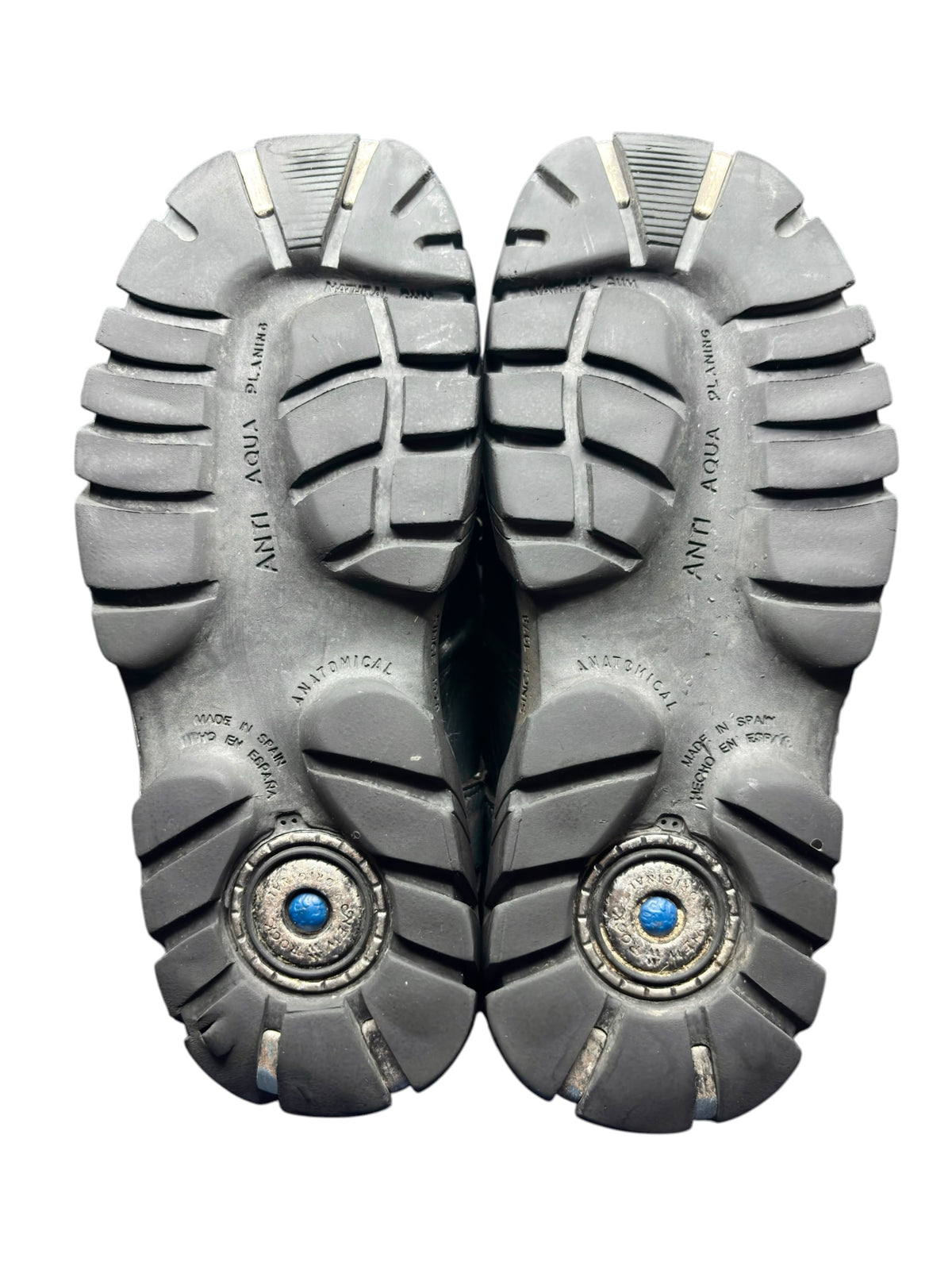 Pair of black platform boot soles with deep tread and two blue center hardware caps