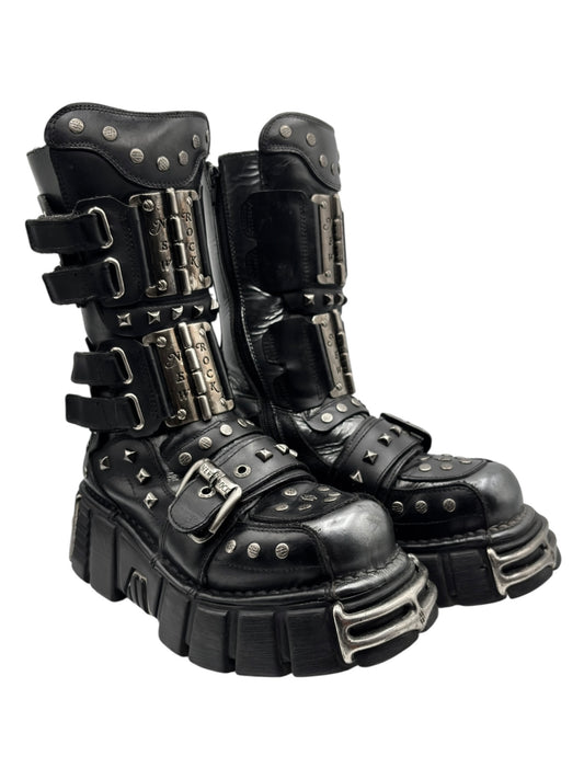 Black mid-calf platform boots angled view, silver studs, and multiple buckle straps