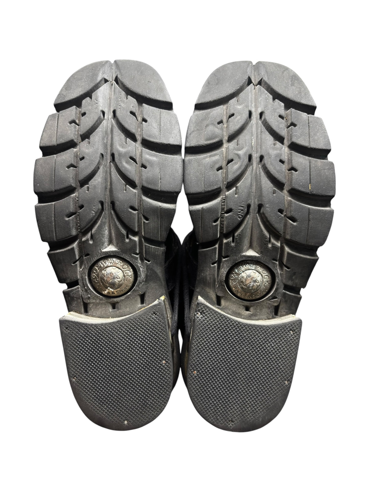 Raised heel ankle boot soles with tread pattern and metal emblem