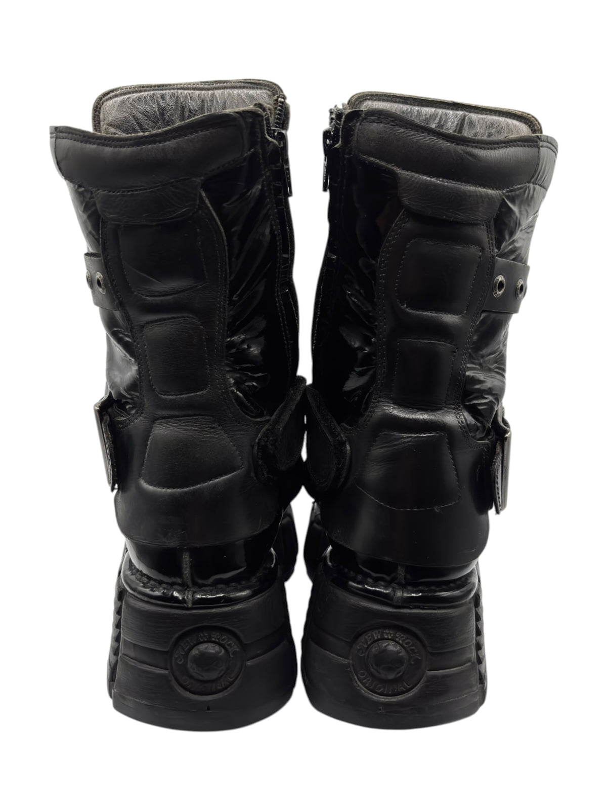 Vintage black leather boots back view with zipper panels and round embossed sole detail
