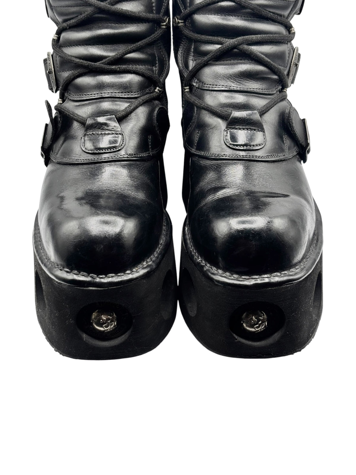Front view of vintage black platform boots with lace-up and toe-buckle straps