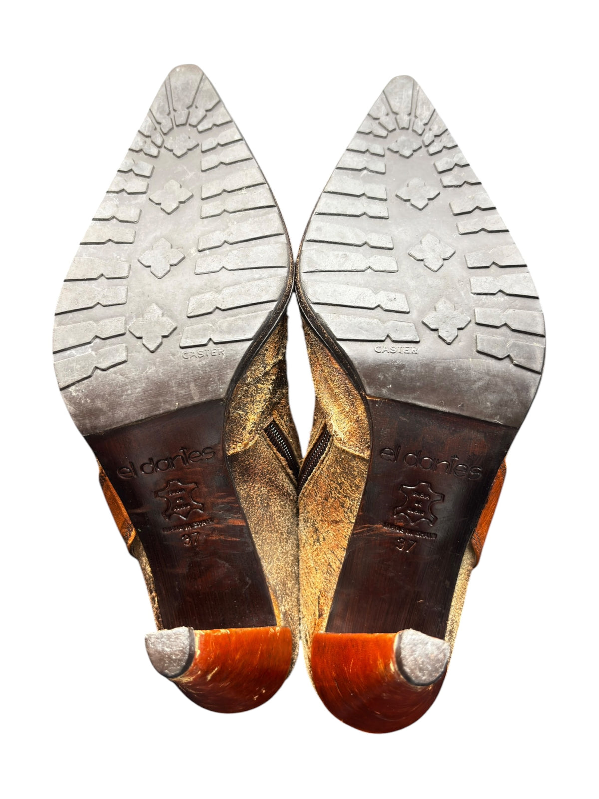 Pair of vintage leather heels with embossed traction soles, viewed from the bottom