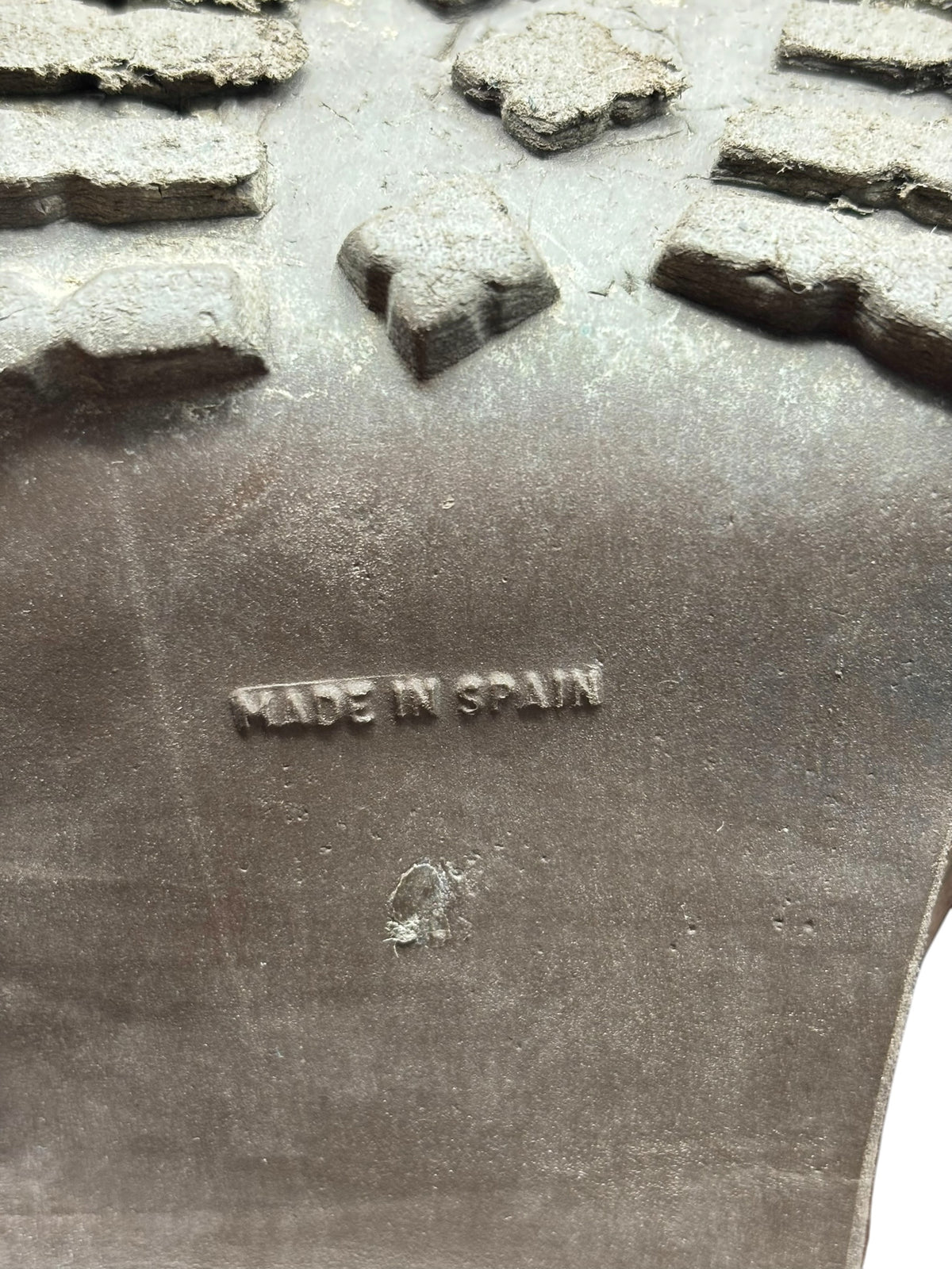 Boot outsole underside with “MADE IN SPAIN” branding and molded tread shapes