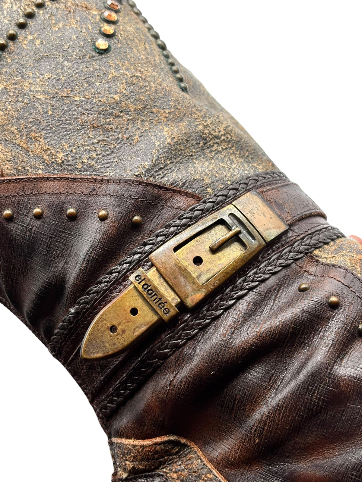 Close-up of side strap detail with gold-tone buckle on vintage brown leather boot