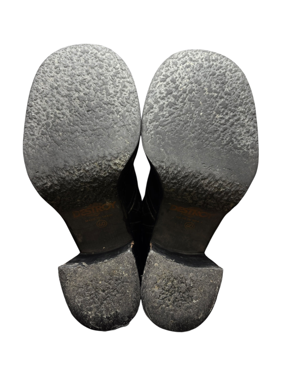 Pair of black knee-high leather boots with textured outsoles and block heels visible.
