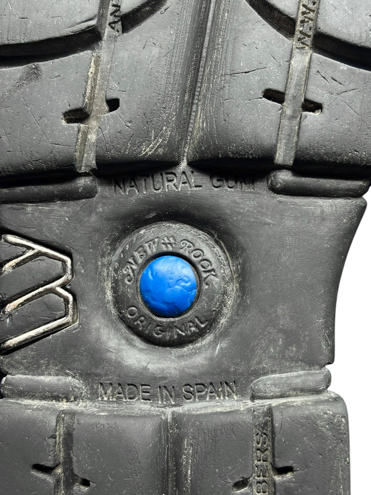 Vintage platform boot sole detail with blue logo button and Made in Spain stamp