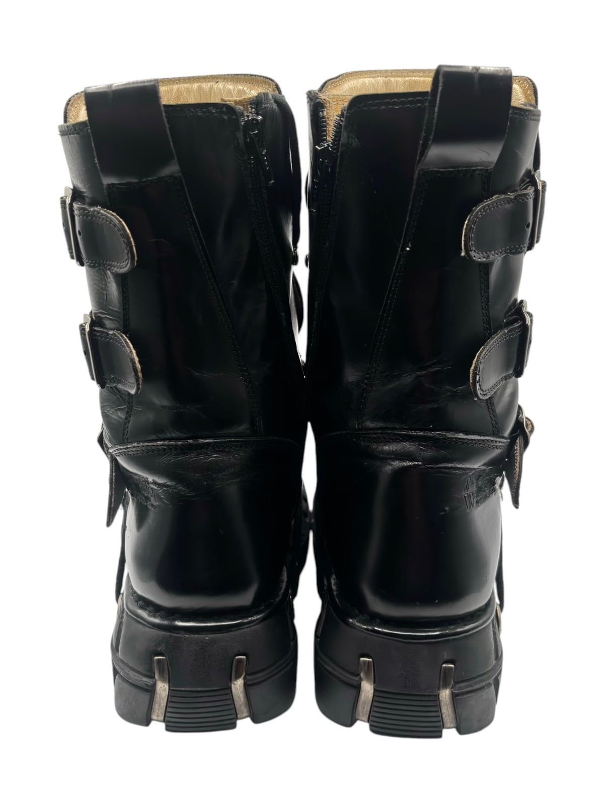 Back view of black platform boots with rear pull tab and strap buckles, paired.