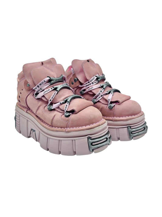 Pink platform lace-up boots with thick tread sole and metal-buckle eyelet details