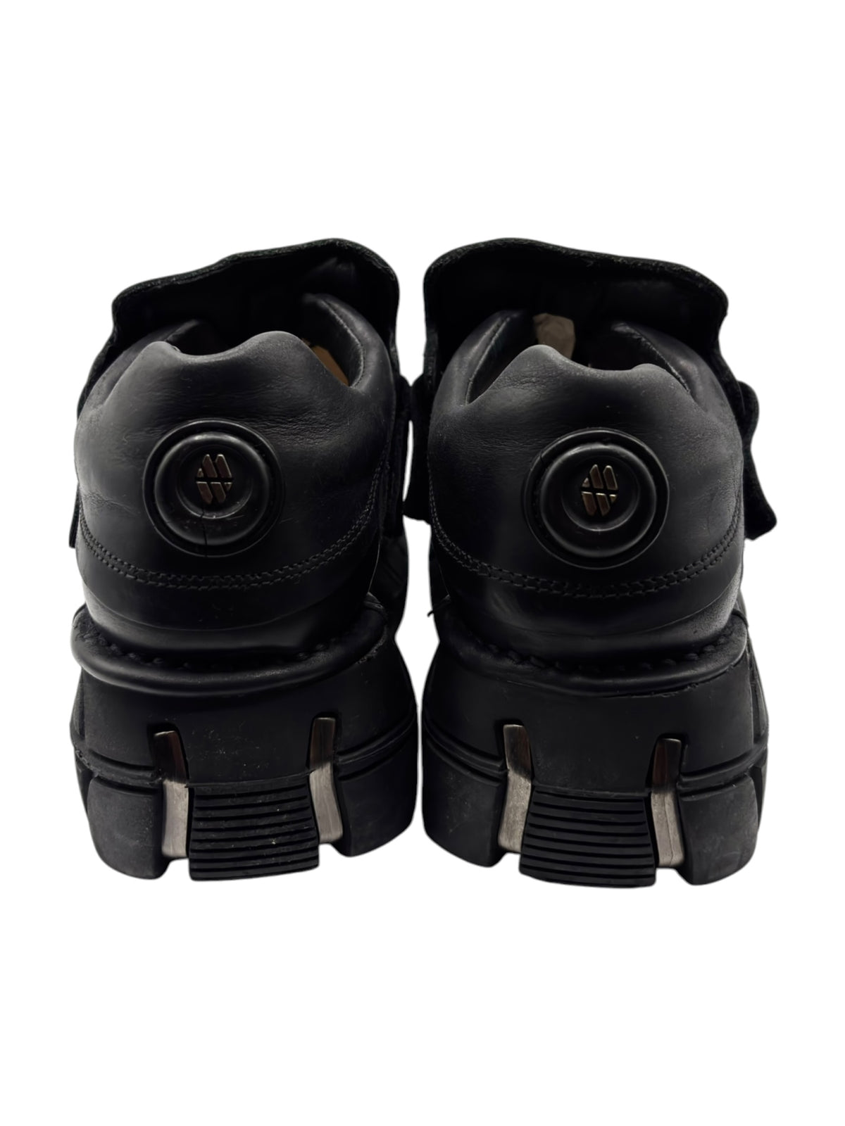 Black New Rock platform boots heel view with round logo and ribbed heel tread