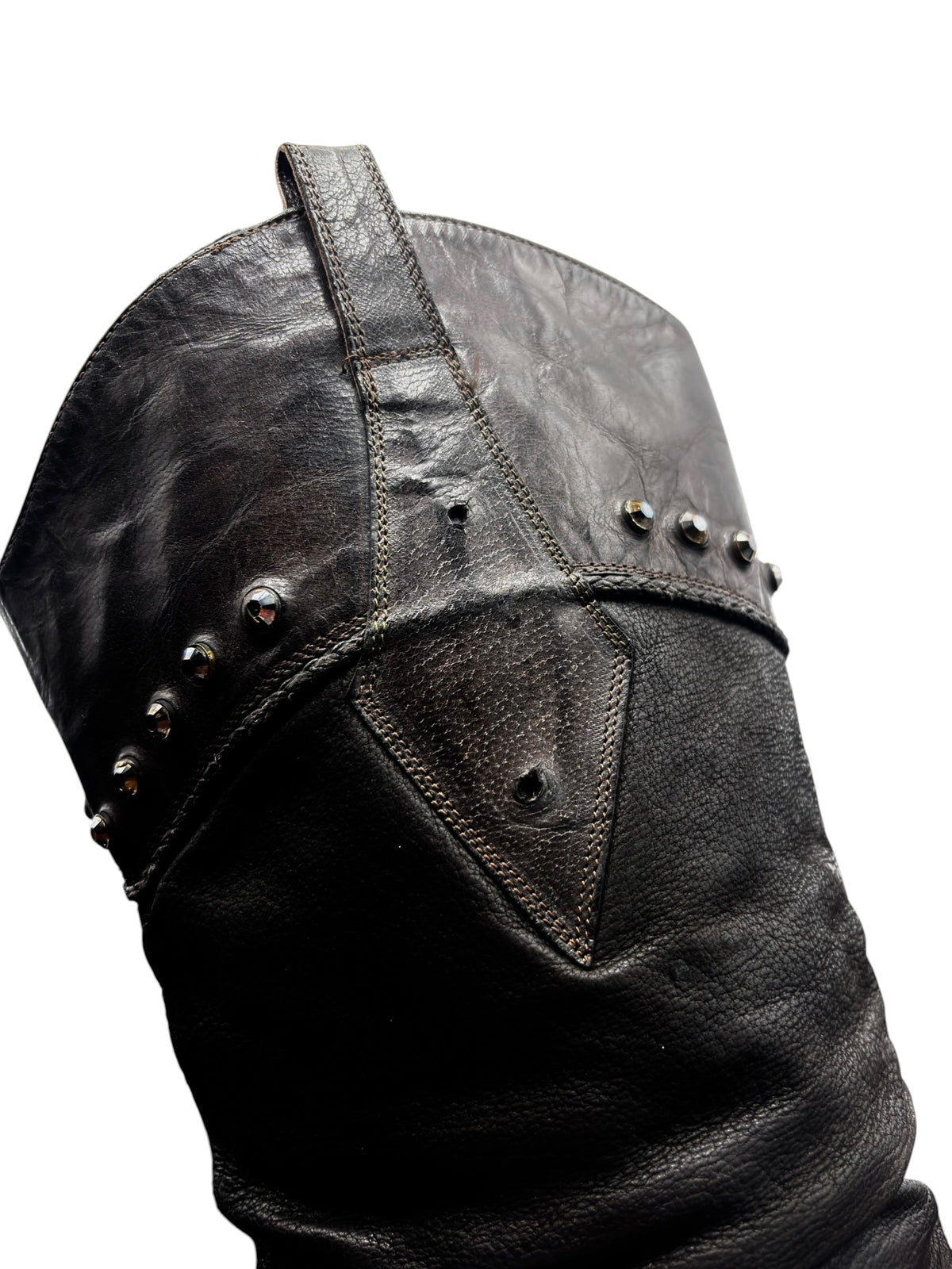 Vintage knee-high leather boots close-up with studded trim and diamond-pattern side panel