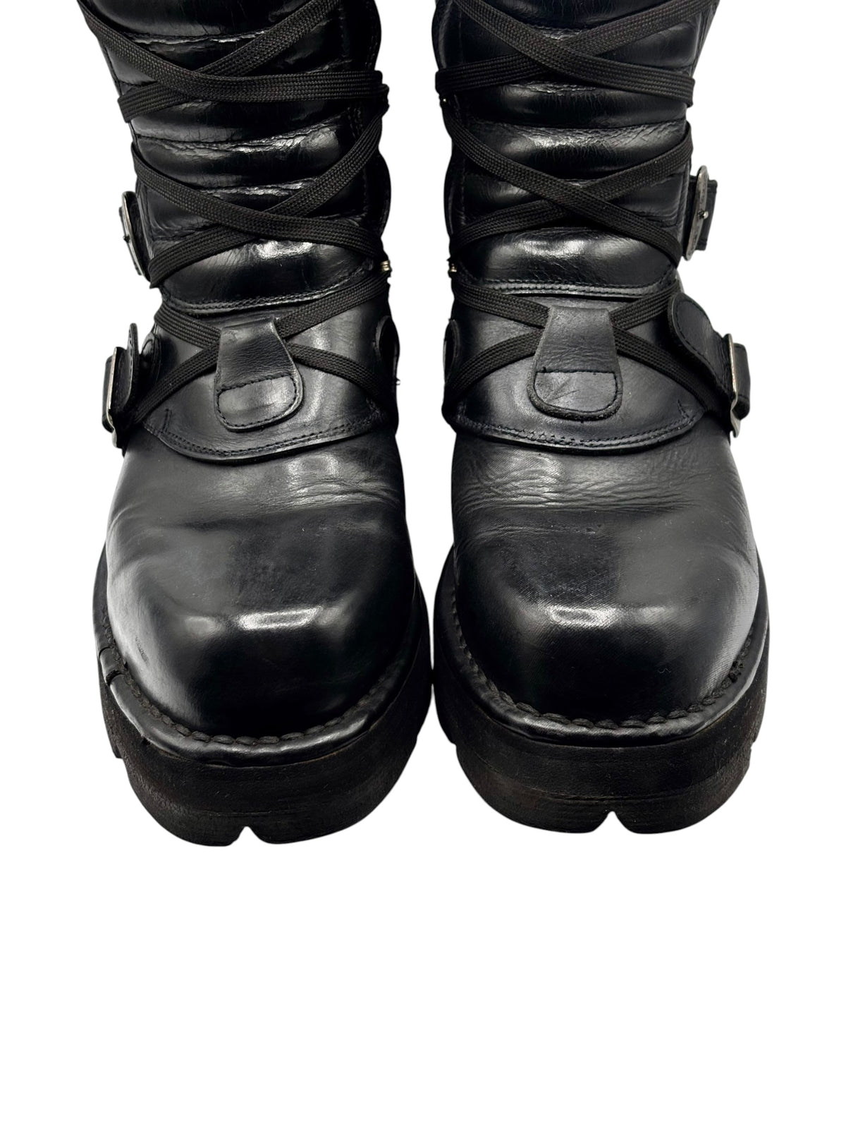 Front view of black leather boots with lace-up detail and rounded toe platform