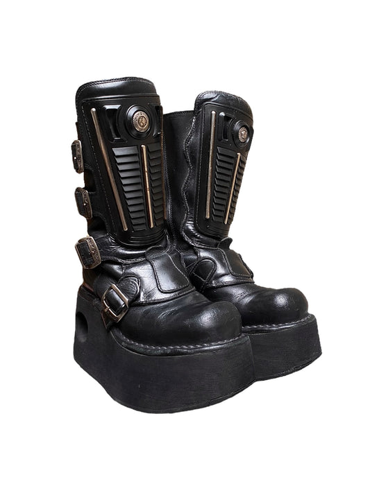 Black leather platform boots with tall straps and buckle details, ankle height