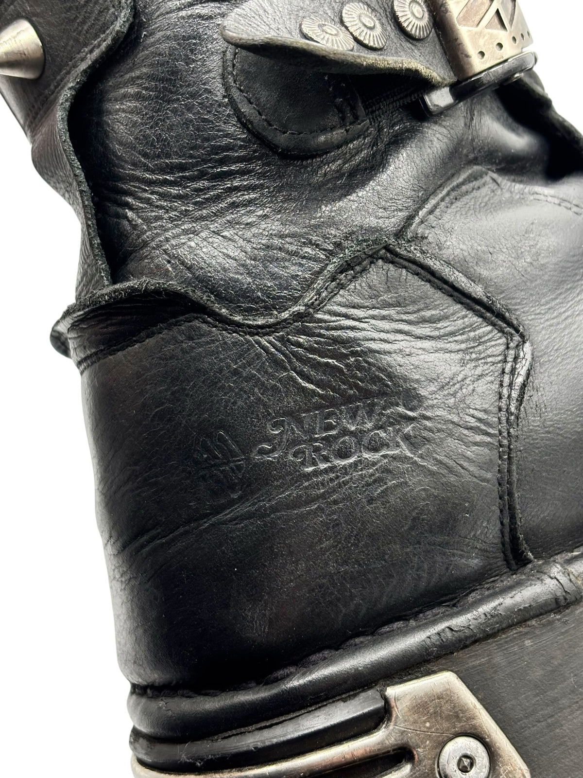 Black leather boot upper with visible stitching and embossed brand on side panel