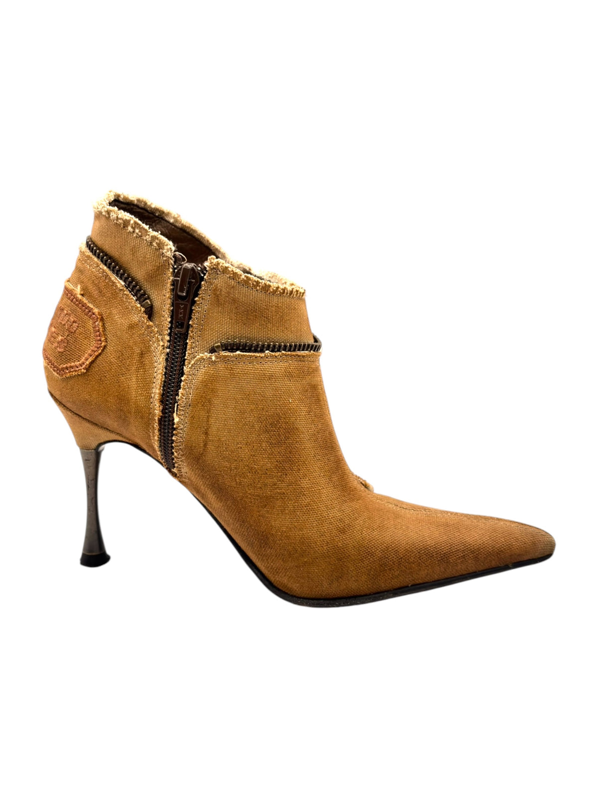Tan ankle boots with high heels, pointed toe and fuzzy trim at the collar