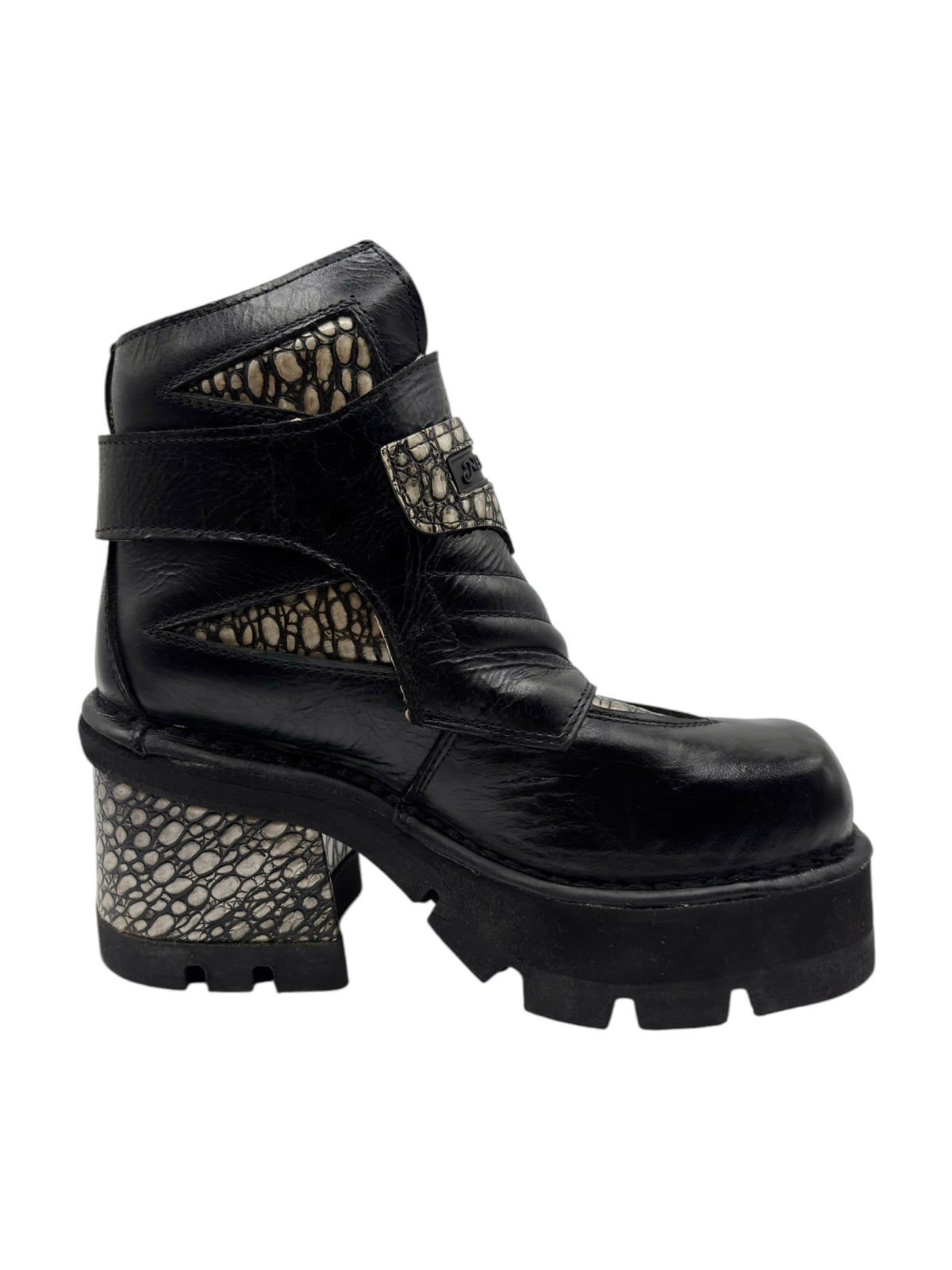 Black platform ankle boot with side cutouts and textured patterned heel panel.