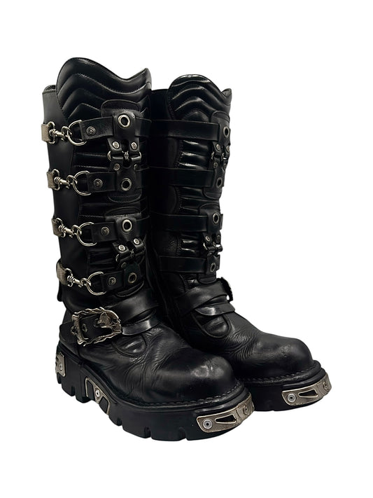 Black knee-high leather boots with multiple straps, buckles, and chain accents