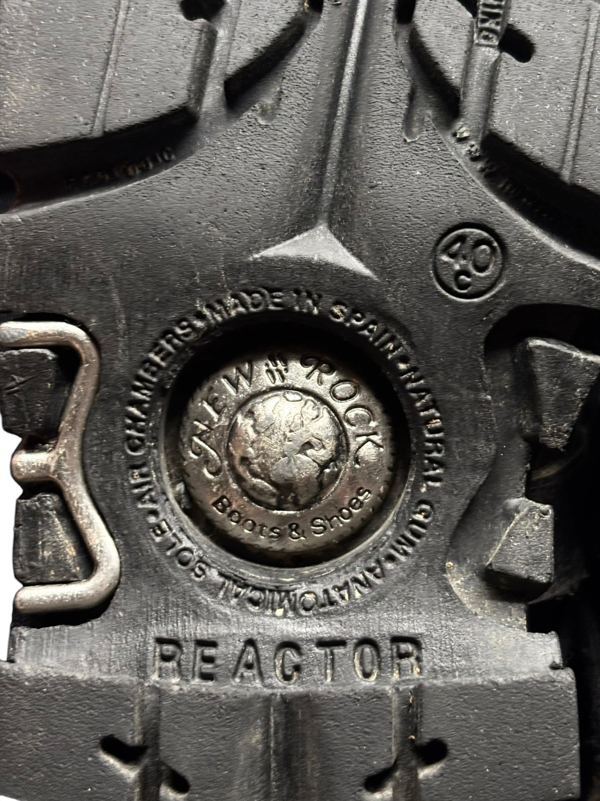 Black boot sole with embossed circular New Rock logo and BEACTOR text