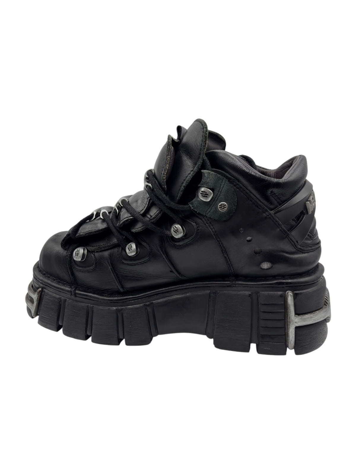 Black leather lace-up platform boots with strap overlays and chunky tread sole.