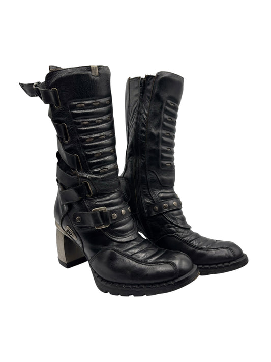 Black mid-calf biker leather boots with buckled strap and stacked block heel