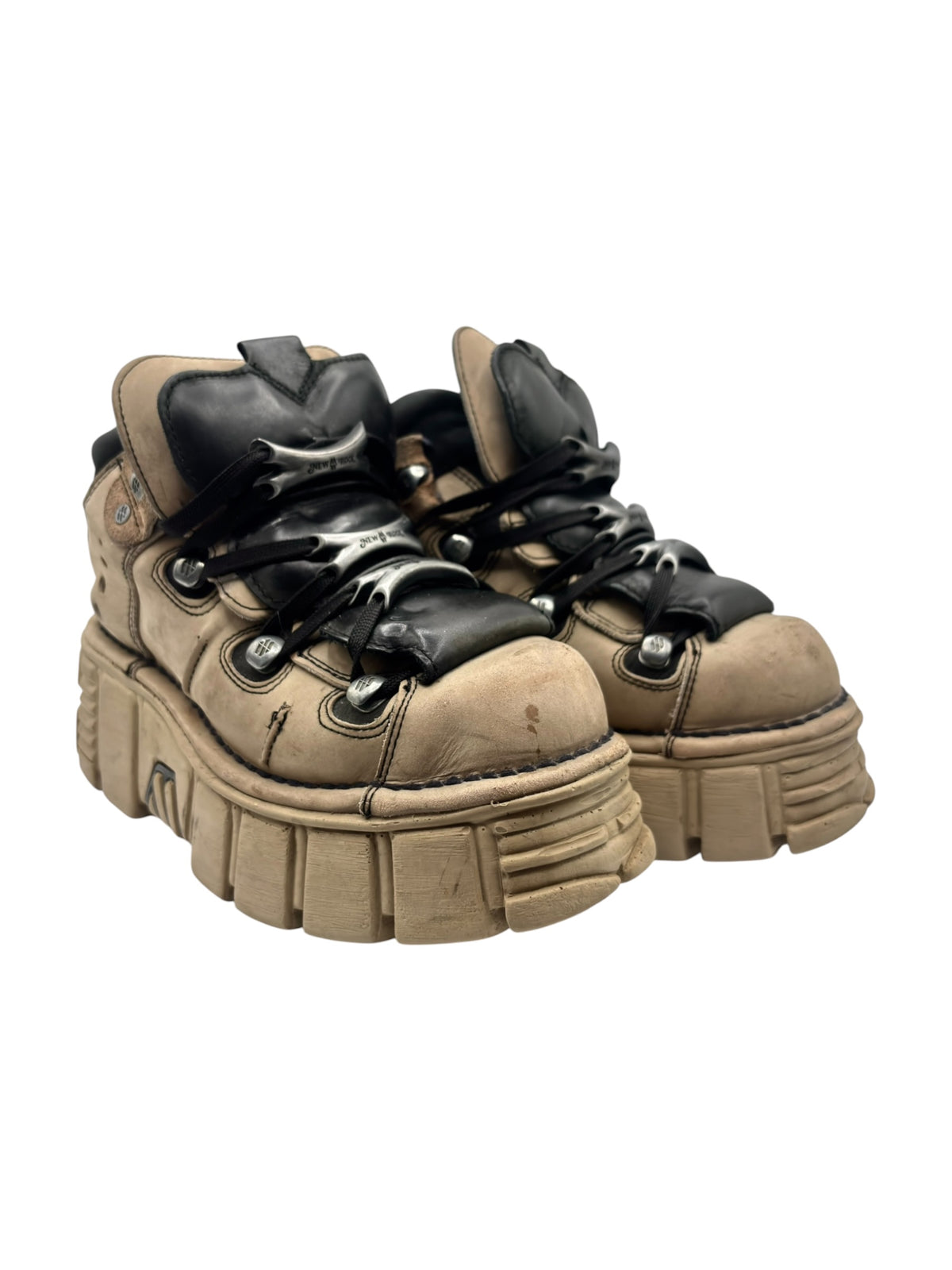 Beige and black platform boots with lace-up closure and thick tread sole