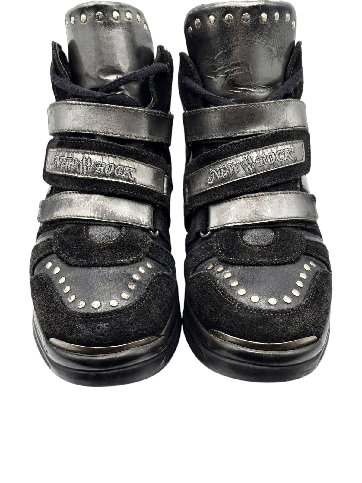 Front view of black suede and leather sneakers with two gray straps and studs