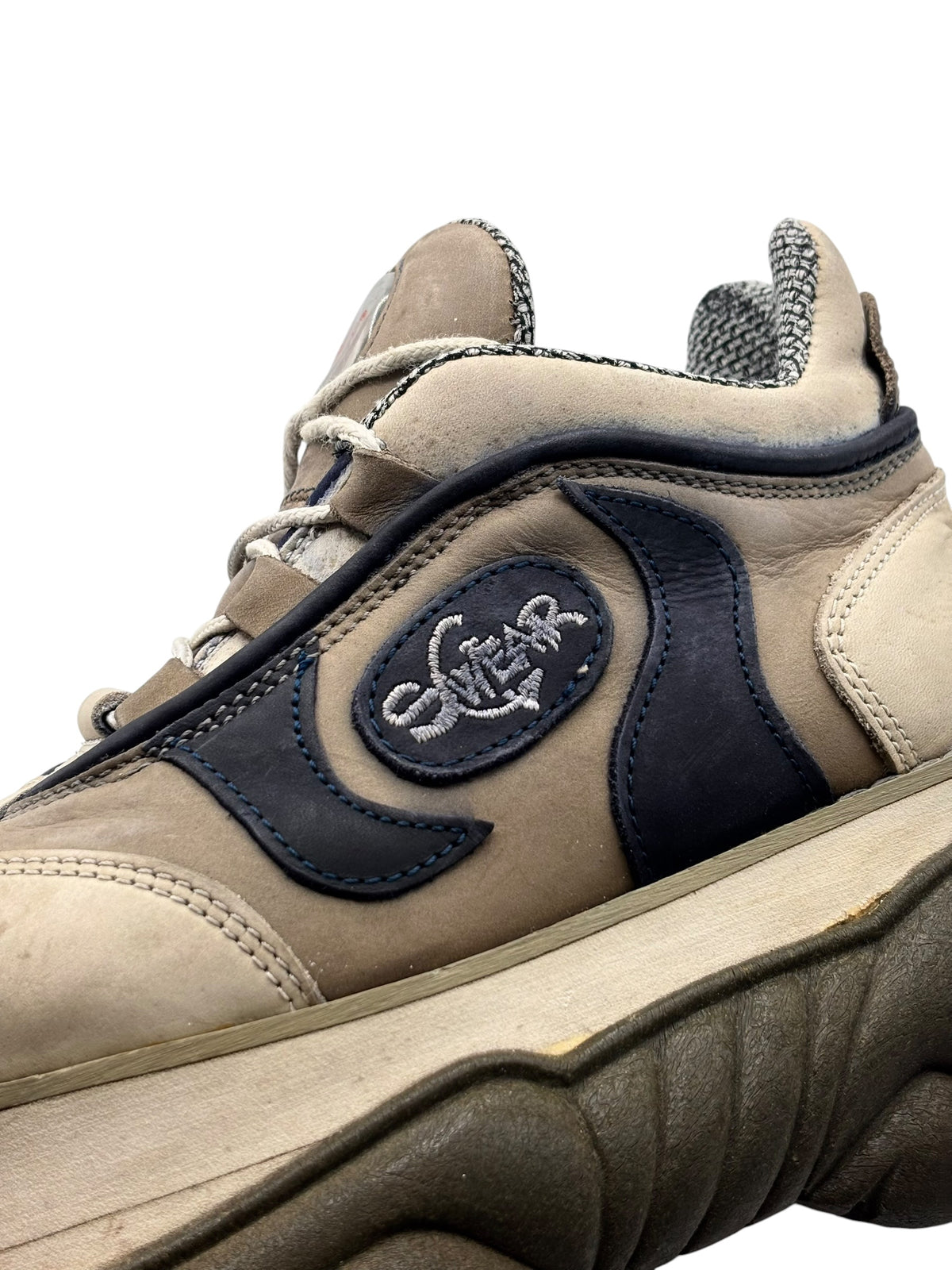 Beige and navy lace-up platform boot with circular Swear patch on side panel
