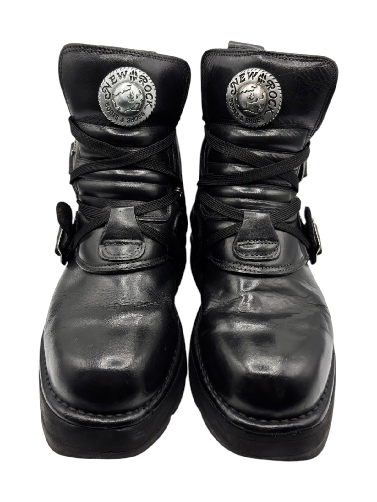 Black leather lace-up boots with raised heel, side buckles, and metal logo patches.