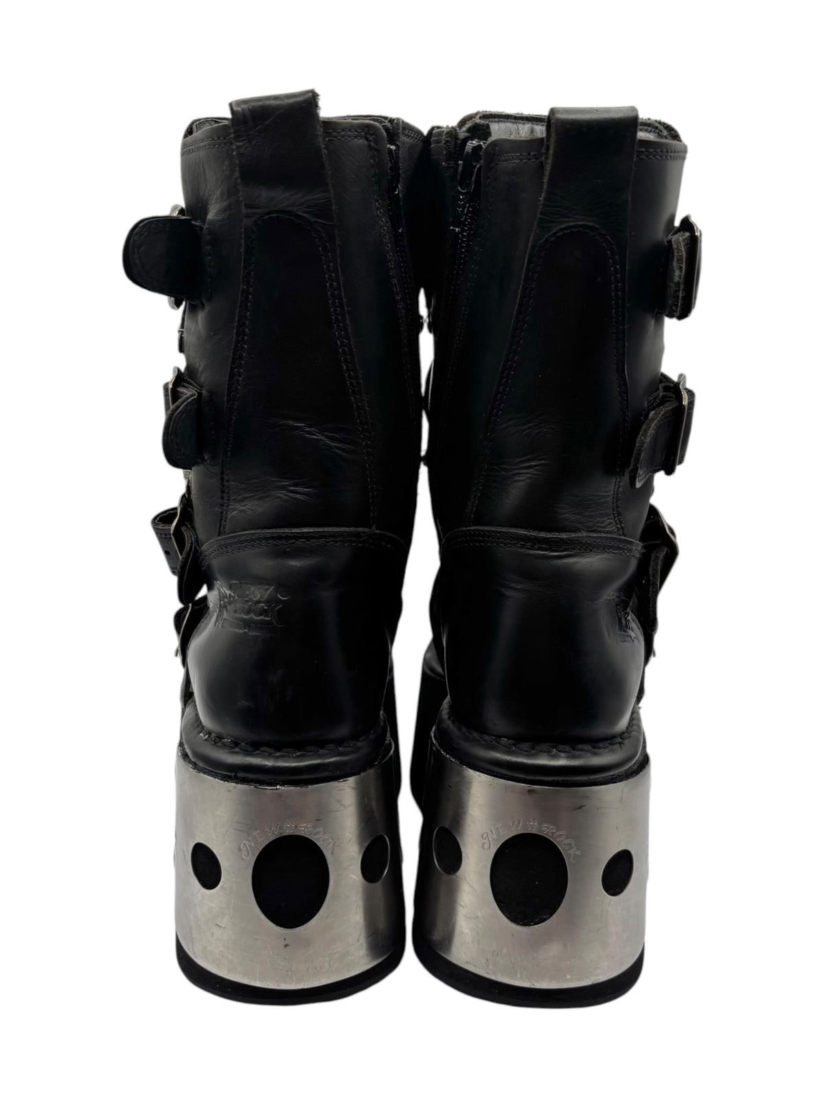 Back view of black platform boots with tall shaft and silver metal heel plates