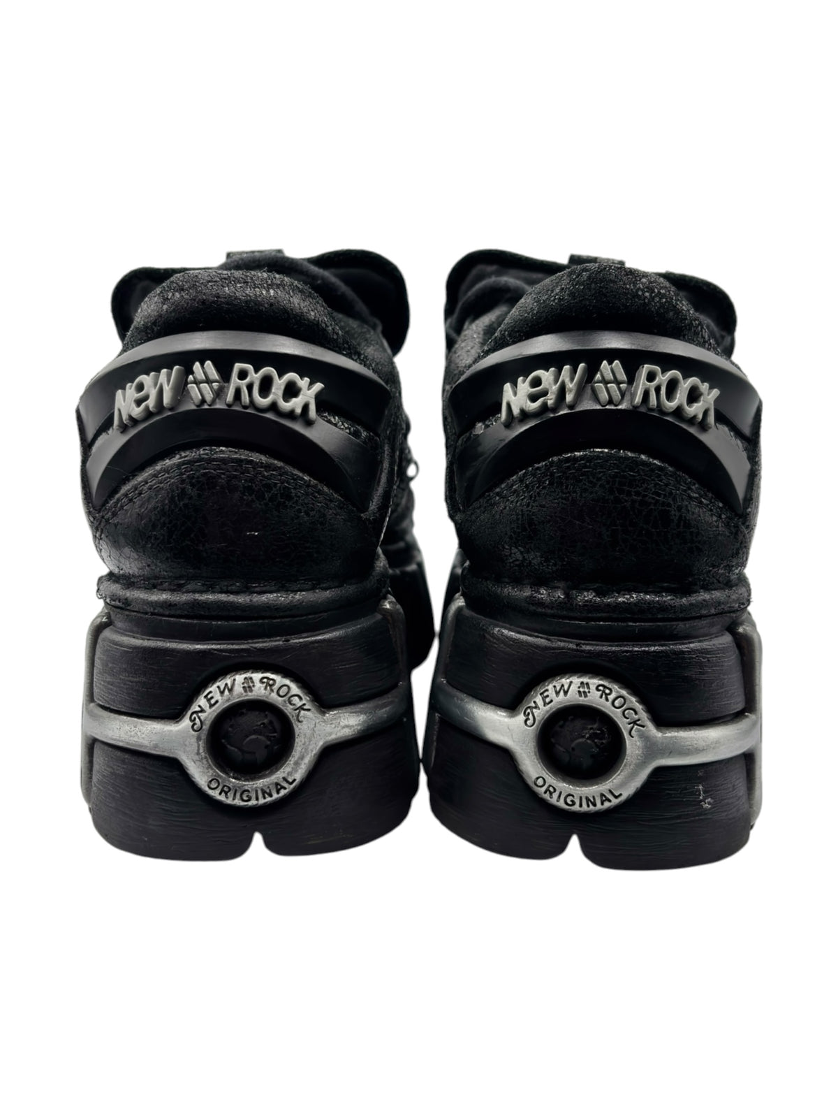 Black platform boots back view with “New Rock” logo patch on heel