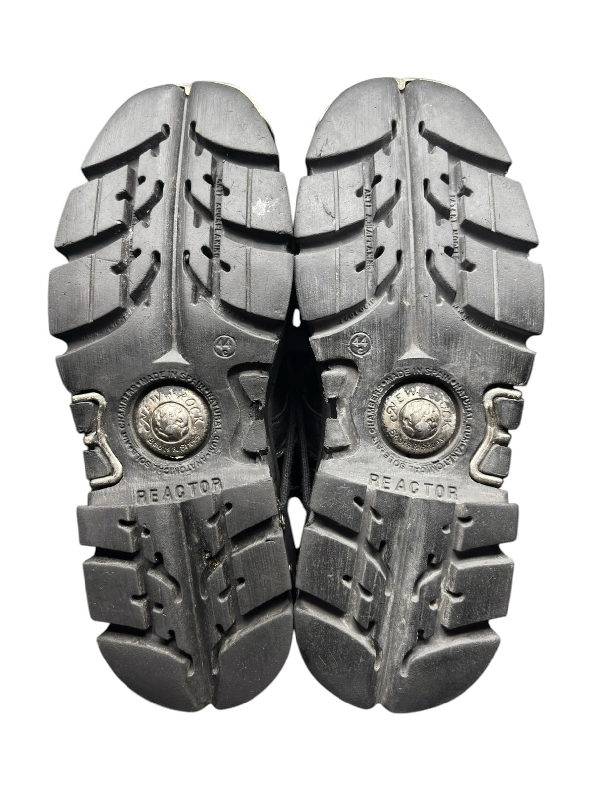 Mid-calf reactor boots with rugged metal-studded soles, pair bottom view