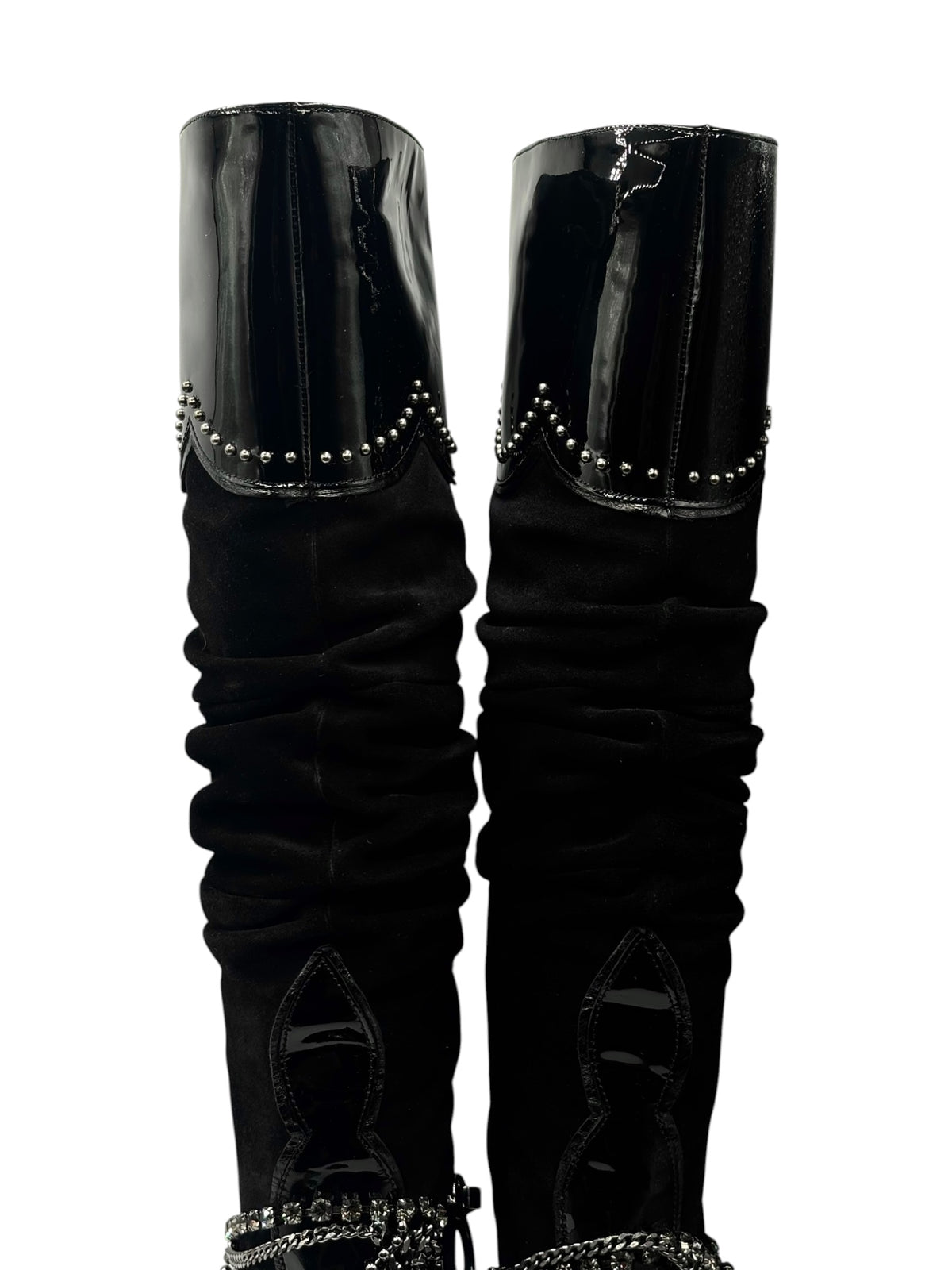 Side view of black knee-high boots with glossy uppers and silver chain trim