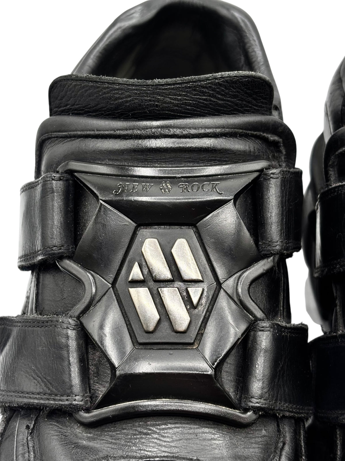 Black leather platform boots with embossed heel logo plate and strap