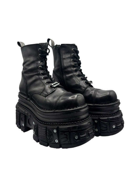 Black lace-up ankle boots with thick platform sole and studded tech straps