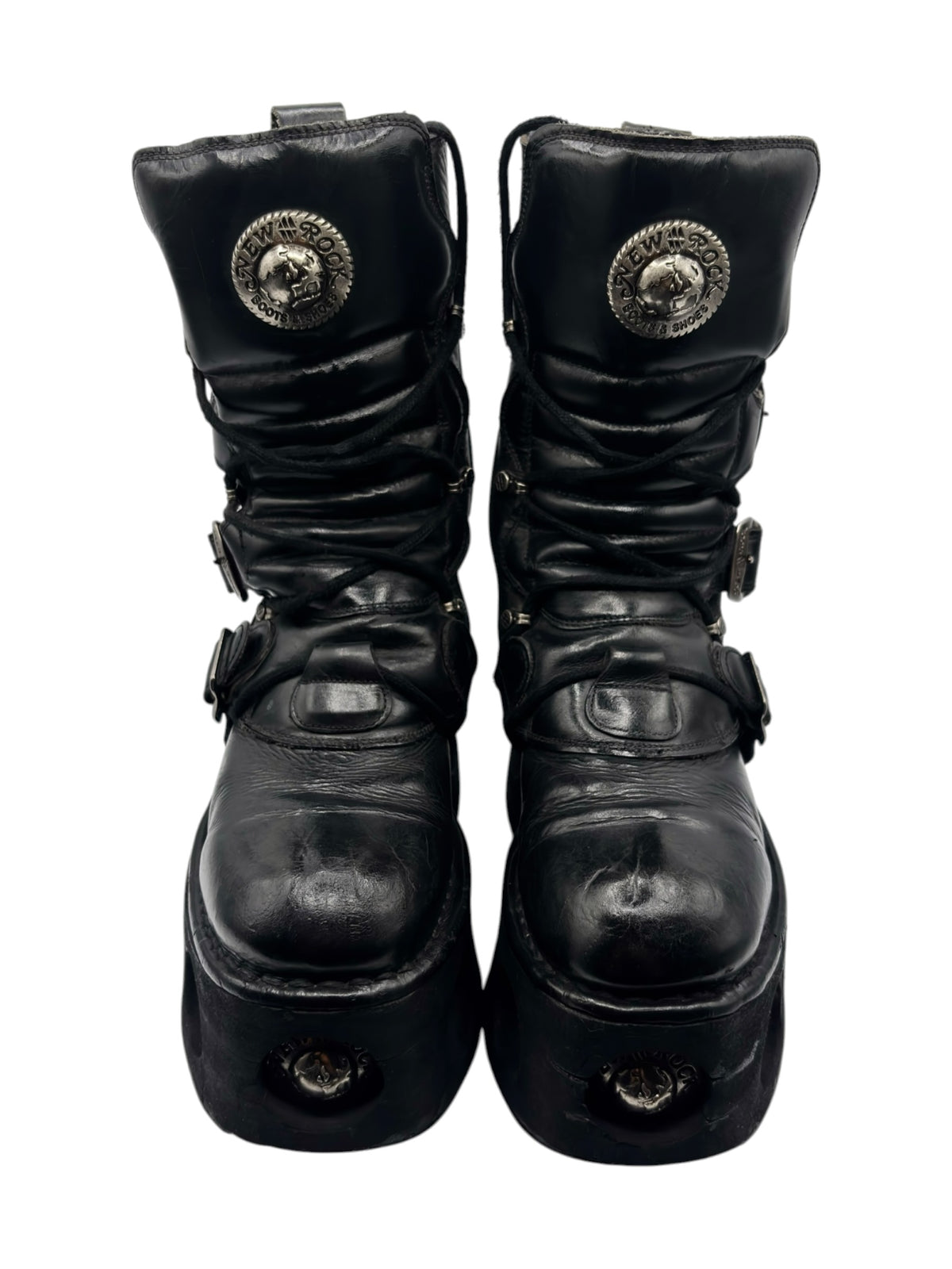 Black mid-calf platform boots with round emblem and side straps