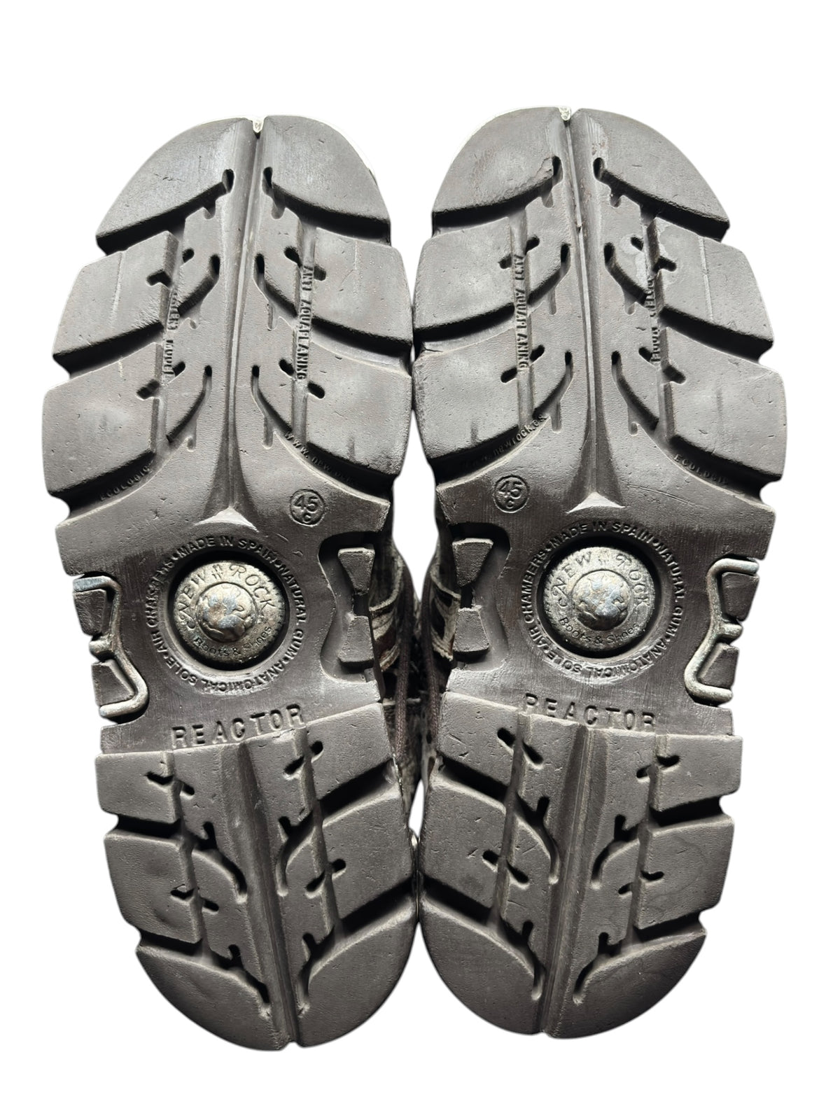 Pair of boot outsoles with 'REACTOR' branding and deep traction tread lugs