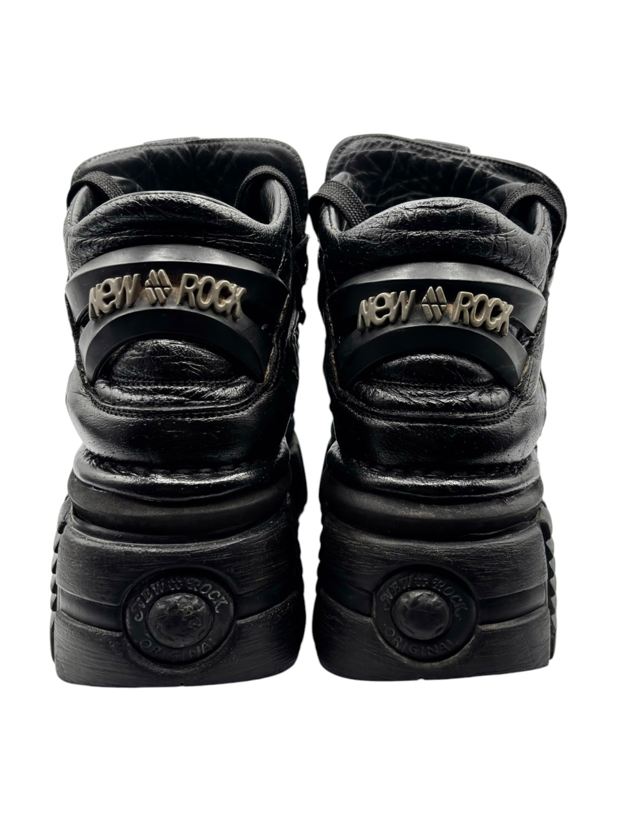 Back view of black platform boots with New Rock text on heel straps