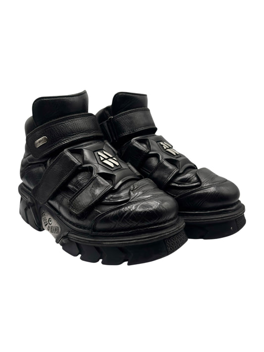 Black leather platform ankle boots with two front straps and metal logo buckles