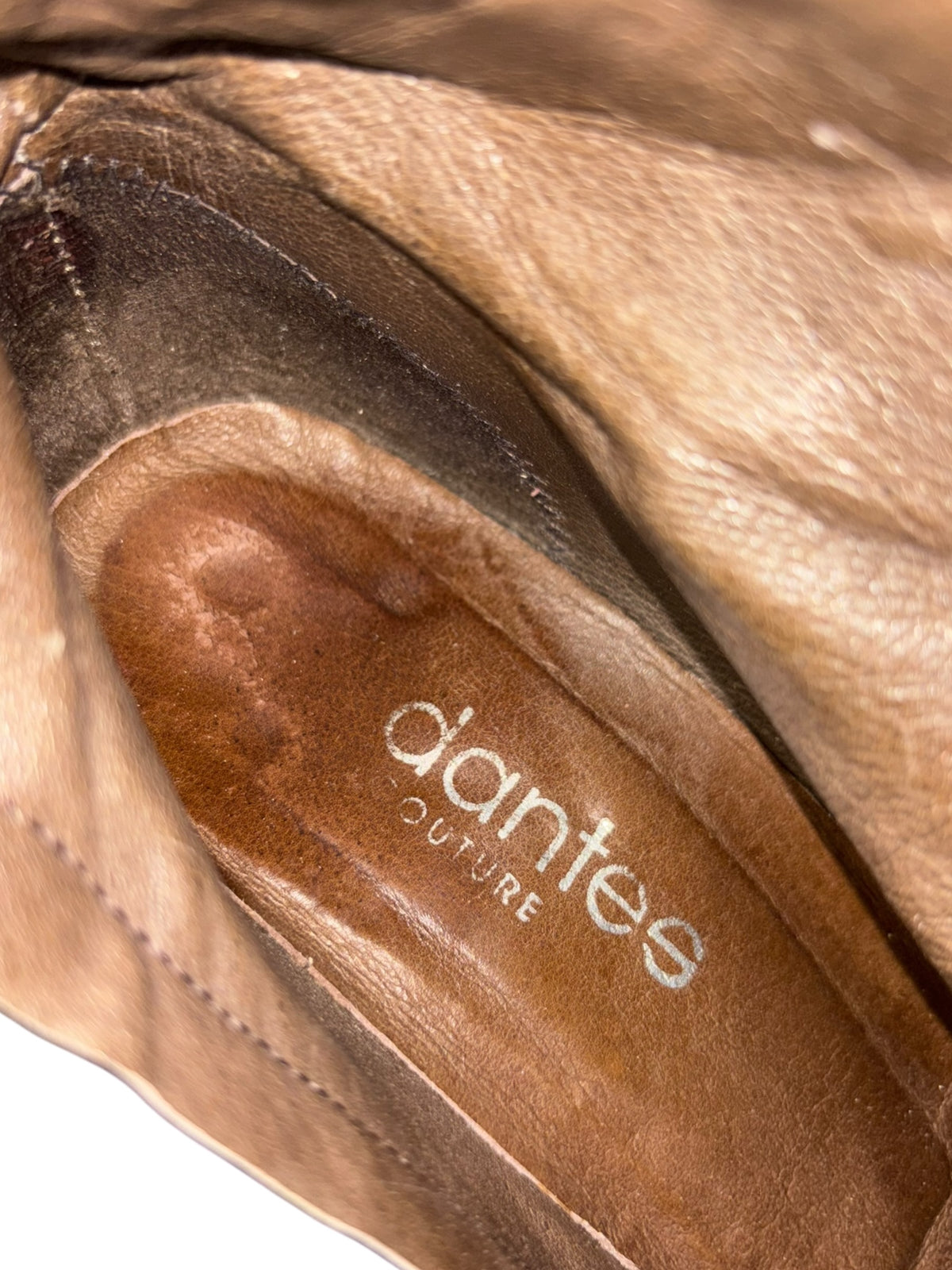 Inside view of tan boot sole with "artes" logo
